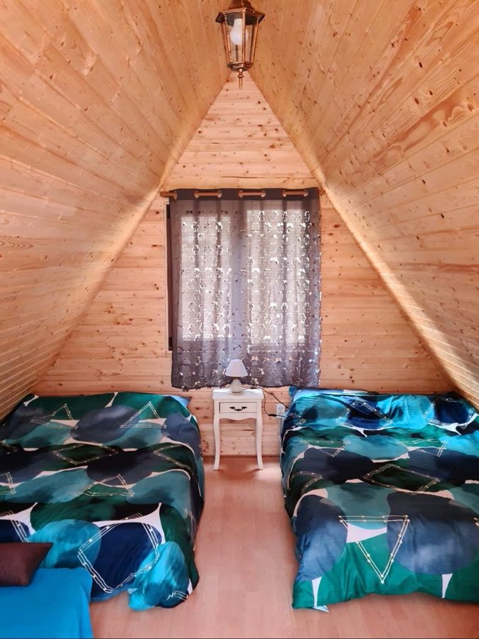 Dormitor în căsuța A-frame, cu două paturi